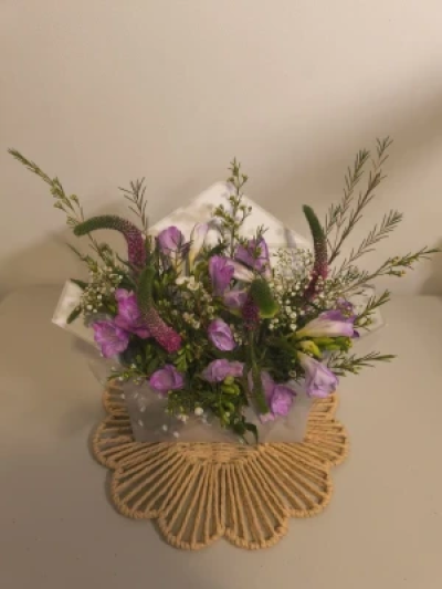 Love Letter in Bloom - A delicate arrangement of seasonal blooms and green foliage, thoughtfully gathered to express love this occasion. A beautiful way to say what words sometimes cannot.