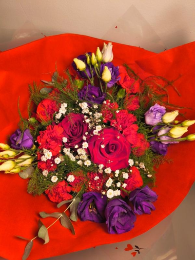 Crimson Enchantment - Bold, romantic, and beautifully dramatic, Crimson Enchantment brings together rich red roses, deep purple blooms, and delicate accents of ivory and gypsophila for a truly captivating display. This bouquet is perfect for marking unforgettable moments — from heartfelt celebrations to elegant gestures of love. A luxurious arrangement designed to leave a lasting impression.

Beautifully wrapped and presented in a water filled gift box.

Please note images are examples only, flowers used may vary due to seasonal availability.